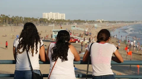 Back view of three women looking at the beach Stock Footage 68909544