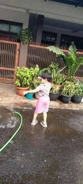 Back View of Three Year Old Boy Enjoying Yard Water Play Stock-Fotos