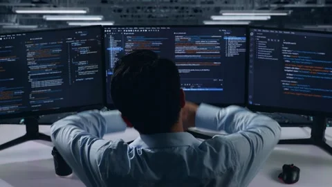 Back View Of Tired Man Developer Stretching While Write Code In Data Center Stock Footage 270227472