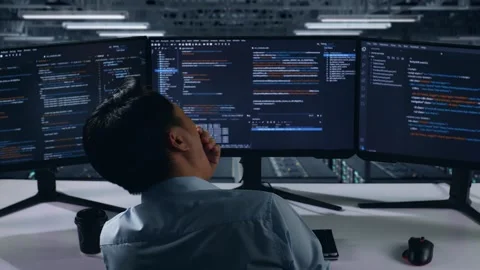 Back View Of Tired Man Developer Yawning While Write Code In Data Center Stock Footage 270227568