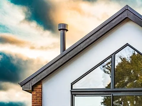 Back view of top of modern brick built house with white walks Stock Photos