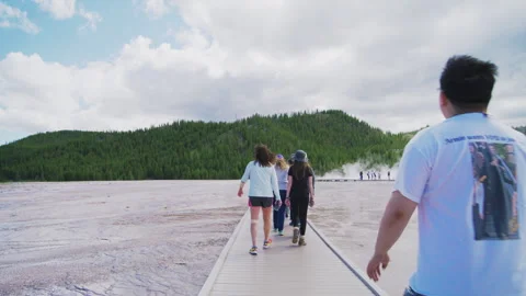 Back view of tourists walking to hot spring in Yellowstone national park, summer Stock Footage 273755087