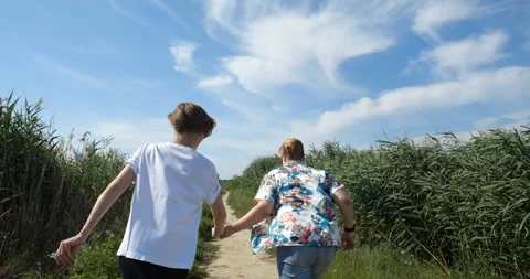 Back view  tracking shot female same-sex couple Stockbeeldmateriaal 135714994