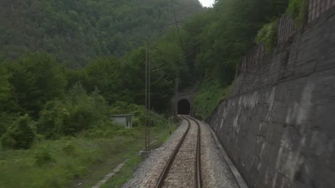Back view to train old track with tunnels in mountain forest. Vintage railway. Stock Footage 270372813