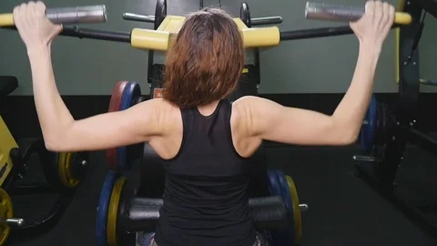 A back view of a trained girl doing exercises Stock Footage 69829484