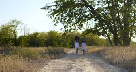 Back view  two beautiful little girls running on dusty country  trail 스톡 동영상 116484173