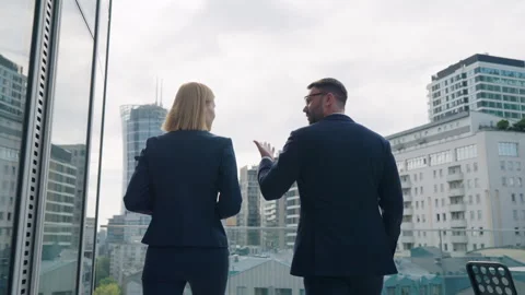 Back view two business partners talk walking modern office building roof terrace Stock Footage 249104885