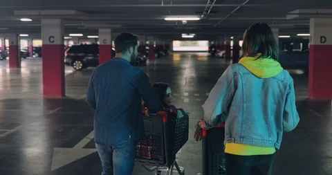 Back view on the two Caucasian man walking in the empty parking space, talking Stock Footage 101028456