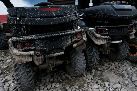 Back view of two dirty muddy quad bikes. Off-road extreme transportation Stock Photos