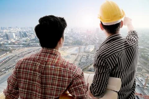 Back view two engineer discussing project Stock Photos