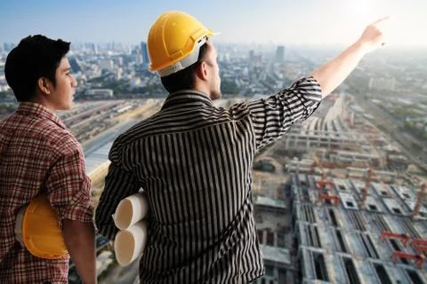 Back view two engineer discussing project Stock Photos