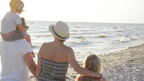 Back View of Two Little Sisters and Happy Mother and Father Walking Together Stock Footage 82169141