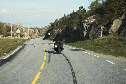 Back view of two motorcyclists on mountain road Stock Photos