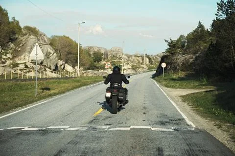 Back view of two motorcyclists on mountain road Stock Photos