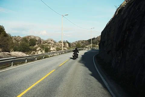 Back view of two motorcyclists on mountain road Stock Photos
