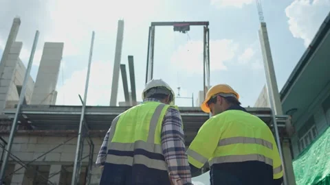 Back view, Two professional male civil engineer or Architect, inspector with  Video stock 213989575
