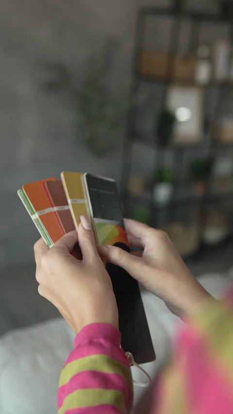 Back view of unknown woman hold yellow color palette at home Stock Footage 292557741