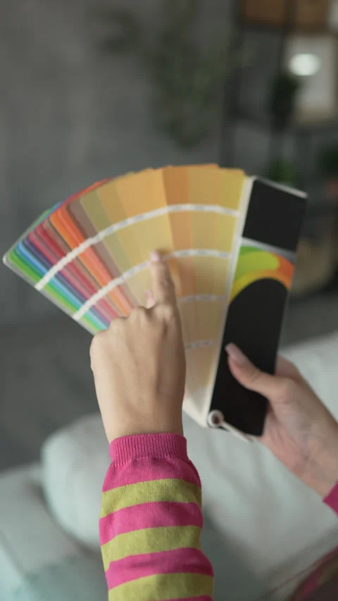 Back view of unknown woman hold yellow color palette at home Stock Footage 292558236