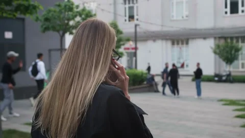 Back view unrecognizable blonde caucasian woman walking outdoors near office 스톡 동영상 242780077