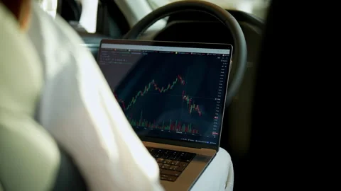 Back view of unrecognizable female trader analyzing stock market data on laptop Stock Footage 283687208