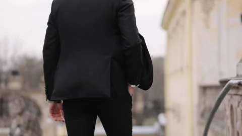 Back view of unrecognizable man walks along the city center street. Confident Stock Footage 196006968
