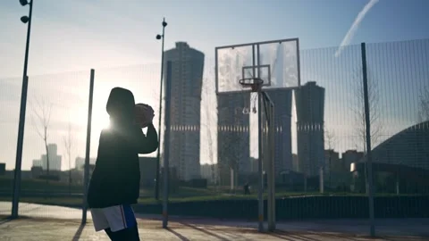 Back view of unrecognizable player throwing ball in a basketball hoop, the ball Video stock 133247945