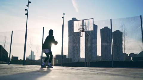 Back view of unrecognizable player throwing ball in a basketball hoop, the ball Video stock 133248516