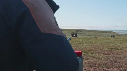 Back view of unrecognizable shooter shooting into target. Gun calibrating before Stock Footage 165905249