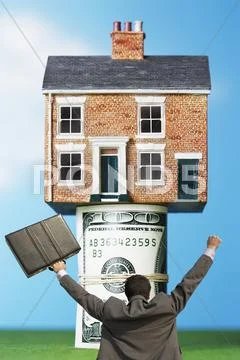 Back view of victorious businessman with briefcase in front of house on money Stock Illustration
