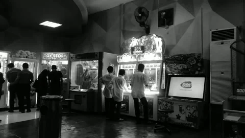 Back view of visitor play token slot machines in Arcade games center Stock Footage 222943637
