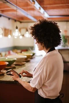 Back view of waitress working with a card terminal Stock Photos