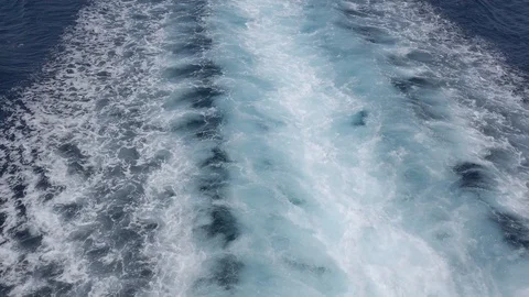 Back view of the wake behind a large cruise ship at sea and port, tilt video Stock Footage 123997743