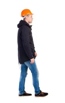 Back view of walking engineer in helmet Stock Photos