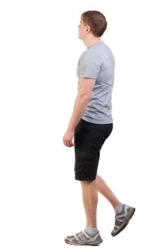 Back view of walking handsome man in shorts and sneakers Foto stock