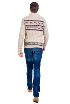Back view of walking handsome man in jeans and warm sweater Stock Photos