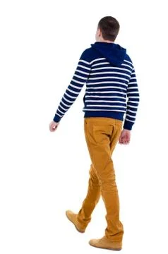 Back view of walking handsome man in jeans and striped sweater Stock Photos