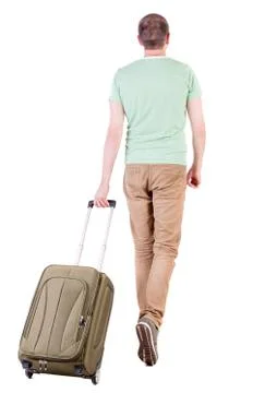 Back view of walking  man  with suitcase Stock Photos