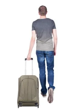 Back view of walking  man  with suitcase Stock-Fotos