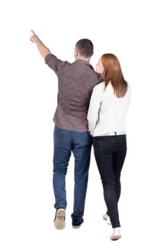 Back view of walking young couple man and woman pointing Stock-Fotos