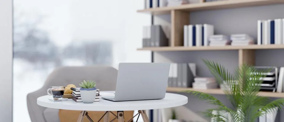 Back view of a white laptop on round table with decors beside the large wal.. Stock Illustration
