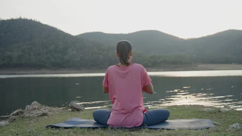 Back view. woman asian doing yoga exercises with praying hand pose at sunset Stock Footage 314095968