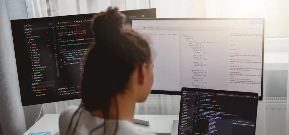 Back view of woman coding on computer, professional female programmer working in Stock Photos