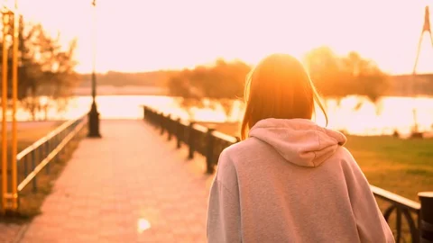 Back view woman jogging alone outdoors Stock Footage 127848660