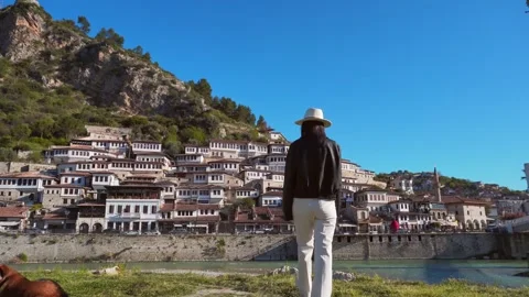 Back view woman in leather jacket lean stand on famous suspension bridge in.. Stock-Footage 333120215