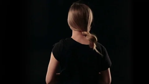 Back view woman letting down blond straight hair Stock Footage