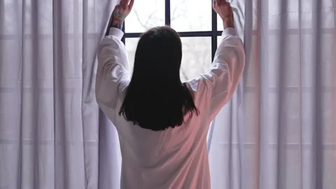 Back view of a woman opening window curt... | Stock Video | Pond5