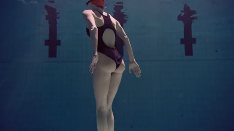Back view of a woman practicing synchronized swimming Stock Footage 283096980