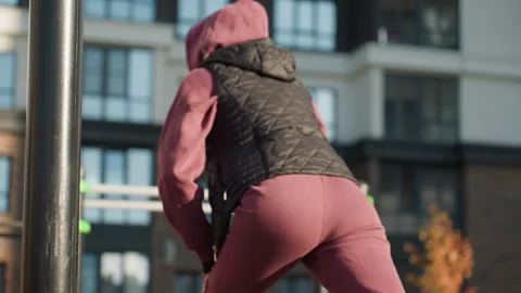 Back View Woman Split Squat Workout Under Soft Sunlight In Urban Garden Stock Footage 316643633