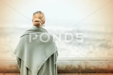 Back View Of A Woman With Tied Blond Hair..