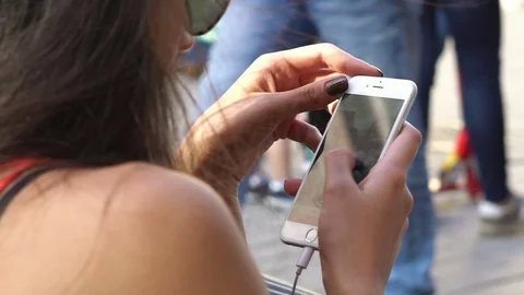 Back view of woman using mobile phone Stock Footage 76997269